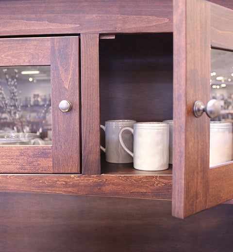 Wooden cabinet with glass doors and mugs inside