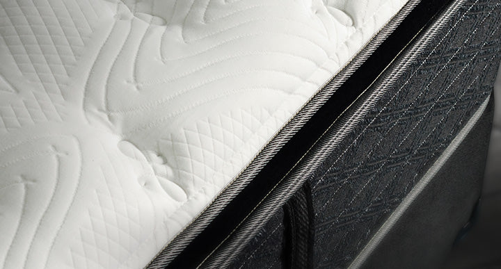 Close-up of a mattress corner, highlighting its texture and stitching.